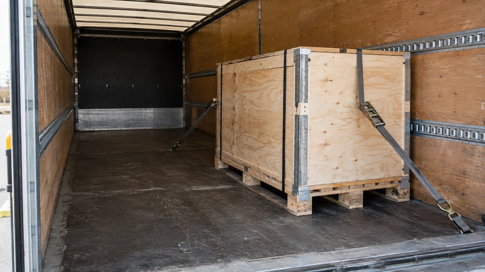 Crated machinery secured inside an enclosed freight vehicle